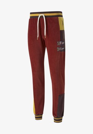 Bordowe dresowe spodnie z cordurowego materiału z żółtymi i brązowymi akcentami, z wiązanym pasem, ściągaczami przy nogawkach i haftowanymi detalami po bokach.