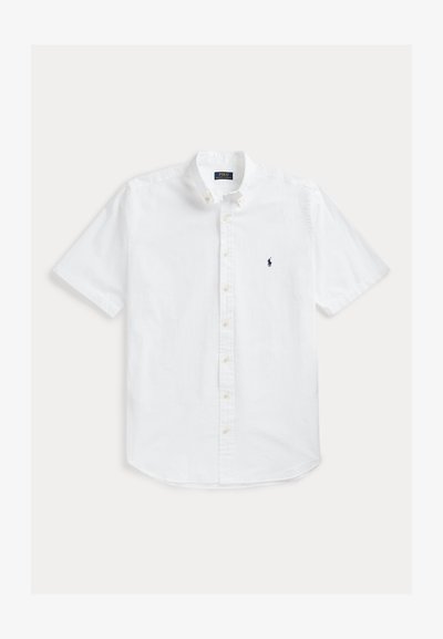 White short-sleeve button-up shirt made of cotton, featuring a classic collar and a small navy logo on the left chest.