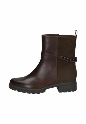Bottine en cuir marron foncé avec dos en suède, bride décorative et détail chaîne, semelle en caoutchouc noire avec un petit talon.