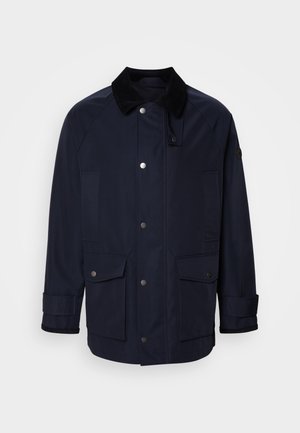 Dunkelblaue Jacke mit einem Cordkragen, Vorderseite mit Druckknöpfen und zwei großen aufgesetzten Taschen. Verfügt über eine Kantenverarbeitung für eine strukturierte Passform.