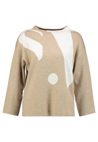 Beige långärmad tröja med överdimensionerade vita abstrakta former och en rund halsringning.