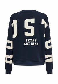 Sweat-shirt bleu marine avec de grandes lettres blanches "JUST" et "TEXAS EST 1876" au dos, col rond et poignets côtelés.
