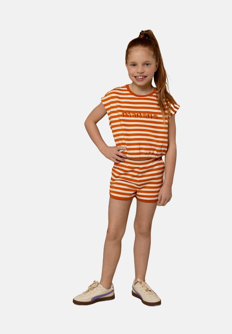 Oranje en witte gestreepte top met korte mouwen en bijpassende shorts. Voorzien van een elastische tailleband en speelse "mahana" tekst op de voorkant.