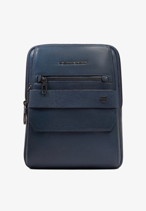 Compacte marineblauwe leren crossbodytas met een voorvak met rits, klepvak en een zilveren Piquadro merklogo op een gladde, gestructureerde oppervlakte.