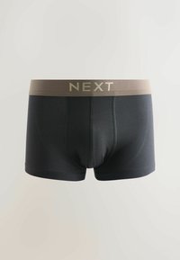 Boxers pour hommes noirs avec une ceinture beige portant le nom de la marque "NEXT" en grandes lettres.