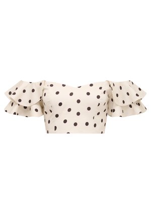 Off-shoulder krem farge crop-top med store svarte prikkede mønstre og lagdelte volanger korte ermer.