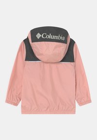 Jasnoróżowa wodoodporna kurtka z czarnym kapturem z logo. Elastyczne mankiety i dolna krawędź, z odblaskowym paskiem dla lepszej widoczności.