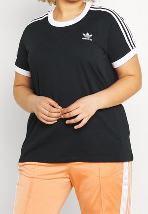 Czarna koszulka z białymi akcentami, żebrowanym okrągłym dekoltem oraz trzema białymi paskami na ramionach. Logo umieszczone na klatce piersiowej.