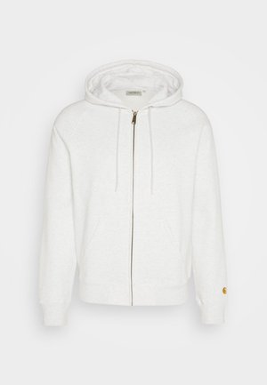 White zip-up hoodie made of soft fabric, featuring a hood, front pockets, and ribbed cuffs. Gold hardware details near zipper.