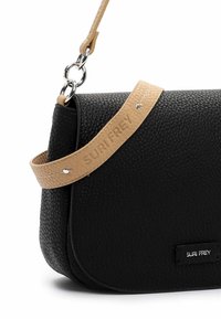 Black textured leather handbag with a curved shape, featuring a tan, embossed shoulder strap and silver-tone hardware accents.