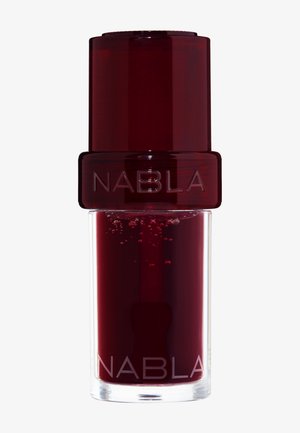 NABLA nail polish in a transparent bottle with a dark red liquid. The cap is glossy and red, featuring the brand name in clear text.