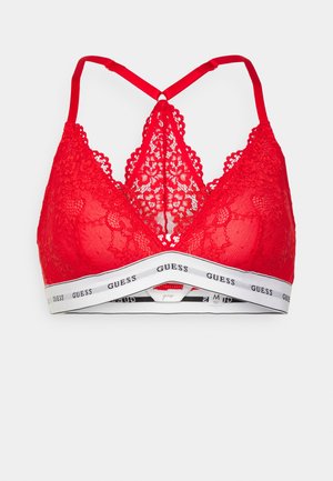 Crvena čipkana bralette s trokutastim čašama, koja ima preplitanje na leđima i bijelu elastičnu traku s crnim "GUESS" brendiranjem.