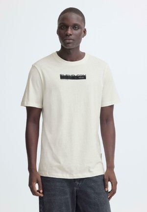 Cremefarbenes Kurzarm-T-Shirt aus weicher Baumwolle mit einem schwarzen rechteckigen Grafikdruck und dem Schriftzug "BLEND CPH" sowie einer lockeren Passform.