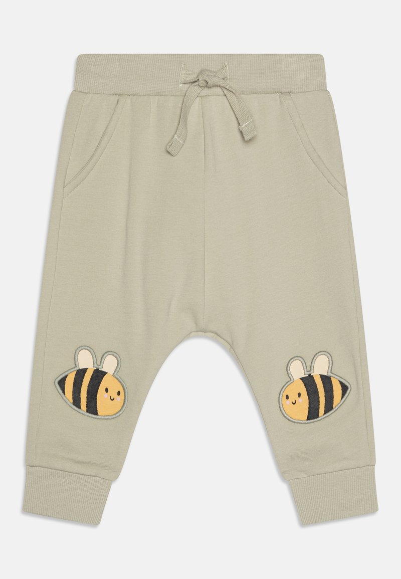 Vaaleanvihreät puuvillajoggerit, joissa on naru vyötäröllä, sivutaskut ja keltaisia pörriäisiä mustilla raidoilla brodeerattuna molemmissa lahkeissa.