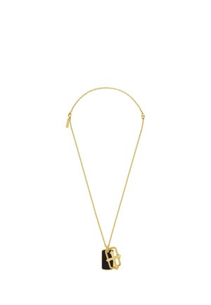 Gold chain necklace with two pendants, one black rectangular and one gold letter B with star accents.