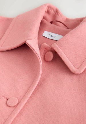Pink wool coat with large collar, featuring round buttons and a smooth texture. Tag with "NEXT" visible inside.