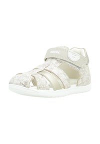 Sandalias de purpurina plateada con diseño abierto, correa ajustable, plantilla acolchada y suela de goma blanca. Logo de la marca en la correa.
