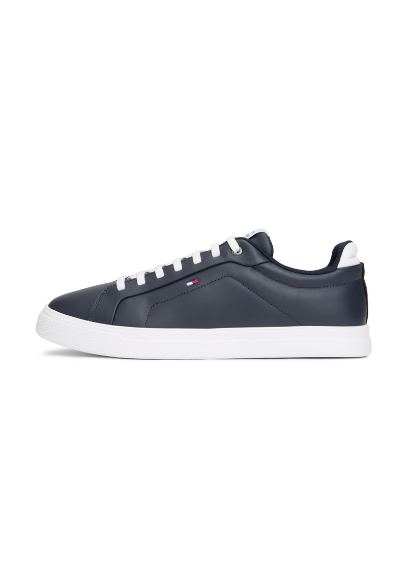 Navy blue leather sneakers with white rubber soles, featuring a streamlined design, contrasting white laces, and subtle logo detail.