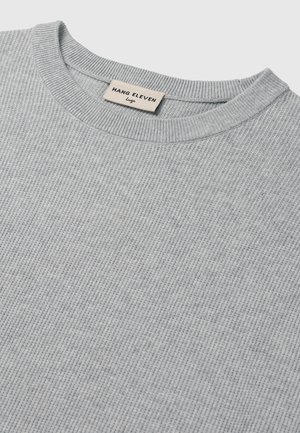 Light gray ribbed sweater with a crew neckline. Features a tag labeled "HANG ELEVEN" in a casual font. Soft texture and simple design.