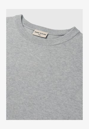 Light gray ribbed sweater with a crew neckline. Features a tag labeled "HANG ELEVEN" in a casual font. Soft texture and simple design.