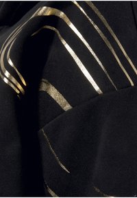 Schwarzer Stoff mit goldenen metallischen Streifen; glatte Textur mit einem subtilen Schimmer und variierenden Breiten, die ein dynamisches Design schaffen.