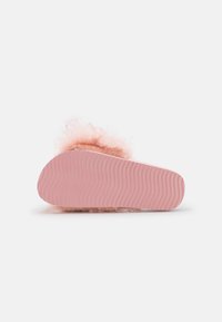 Fuzzy pink slipper with a soft, fluffy upper. Outsole is smooth pink rubber with a wavy texture. Slightly rounded shape with no visible hardware.