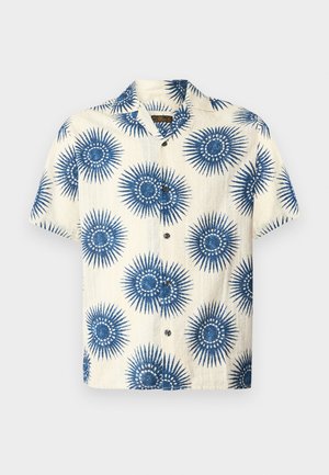 Chemise boutonnée à manches courtes couleur crème avec un motif floral bleu en éclats de soleil et un col camp.