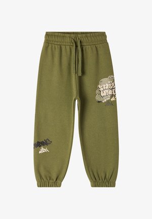 Oliwkowe dresy z elastyczną talią i sznurkiem. Posiadają graficzne nadruki w czerni i bieli na dolnej części nóg.