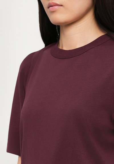 Burgundy short-sleeve t-shirt with a round neckline. Soft, smooth fabric with a subtle texture and casual fit. No visible patterns or accents.