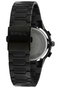 Montre en acier inoxydable noir avec un bracelet à maillons hexagonaux, présentant une finition mate et un fermoir poli. Cadran lumineux et détails de chronographe.