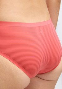 Ροζ ριγωτά εσώρουχα με λείο ελαστικό ζωνάρι στη μέση, χωρίς ραφές και μαλακή υφή για άνεση. Το λογότυπο της μάρκας εμφανίζεται διακριτικά.