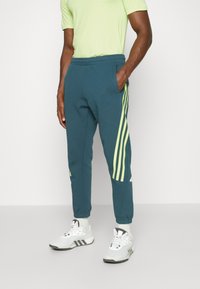 adidas Sportswear FUTURE ICONS 3-STRIPES - Pantalones deportivos - arctic night