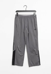 Szare spodnie sportowe z elastycznym pasem, bocznymi kieszeniami i czarnymi akcentami. Wyposażone w logo "UNDER ARMOUR" wzdłuż nogawki. Gładka faktura.