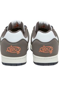 Gray sneakers with white accents, featuring a textured upper, round toe, and a vibrant orange logo detail on the heel. Rubber sole.