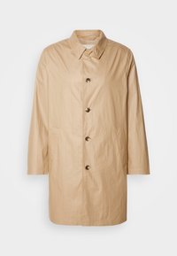 Beige, middellang jasje gemaakt van lichte stof met een rechte snit, knoopsluiting, puntige kraag en zijzakken.
