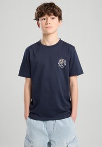Navy blue cotton t-shirt with a round neckline and short sleeves, featuring a white graphic design on the left chest.