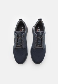 Navy blue sneakers with mesh and suede materials, rounded shape, grey laces, pull tab, and rubber sole. Size indicated as 44.