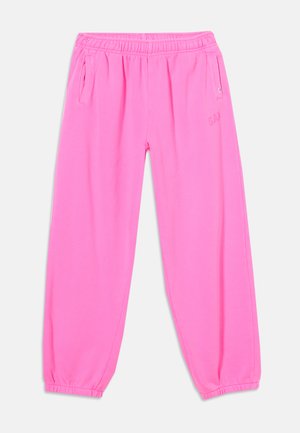 Pantalon de survêtement rose vif à taille élastique, avec poches latérales et poignets élastiques, posé à plat sur un fond blanc.