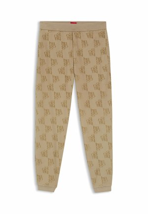 Pantalon jogger beige avec taille et poignets élastiques, présentant un motif en relief avec le logo "hugo" répété sur tout le tissu.