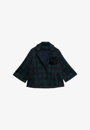 Veste à carreaux en vert foncé et bleu marine avec un col cranté. Elle possède des manches évasées, deux poches avant et un accent en rose en tissu noir au niveau de la poitrine.