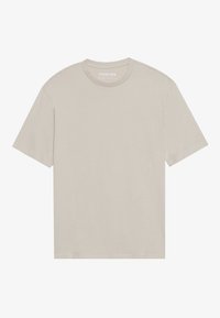 Lys beige bomull t-skjorte med rund hals, korte ermer og en avslappet passform. Har en glatt tekstur og et minimalistisk design.