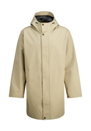 Beige waterproof rain jacket with a hood, front snap closure, side pockets, and a smooth texture. Designed for outdoor protection.