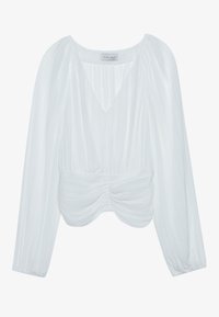 Blusa blanca de manga larga, con un escote en V y textura plisada. Diseñada con una cintura fruncida para dar forma entallada.