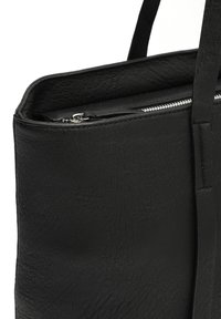Black leather tote bag with a textured finish, featuring a silver zipper closure and flat handles. Minimalist design without patterns.