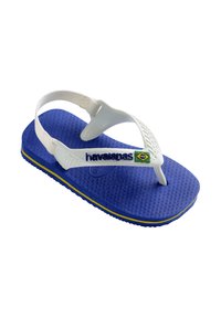 Chancla de goma azul con suela texturizada, tiras blancas y logo de "havaianas". Presenta un acento en verde y amarillo que recuerda a la bandera brasileña.