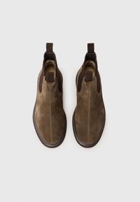 Brown suede ankle boots with elastic side panels and pull tabs, featuring a round toe and textured rubber soles. Flat design.