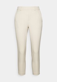 Beżowe dopasowane spodnie o prostym kroju, z mankietami z przodu i bezszwami kieszeniami bocznymi. Gładka faktura materiału bez widocznych wzorów.