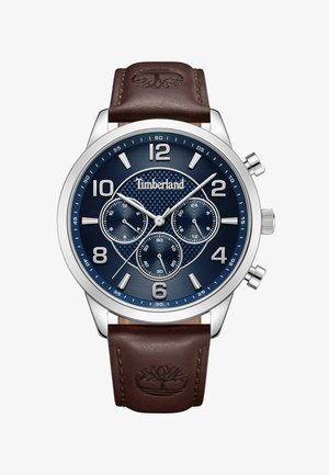 Chronographuhr mit einem navyblauen strukturierten Zifferblatt, einem Gehäuse aus Edelstahl in Silberfarbe und einem braunen Lederarmband mit eingeprägtem Logo.