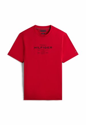 Red cotton t-shirt with short sleeves, featuring a black printed logo and text: "TOMMY HILFIGER NEW YORK CITY Est. 1985."