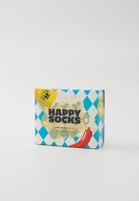 Colorful gift box for socks featuring a blue and white diamond pattern, yellow label, and illustrations of a sausage and beer.